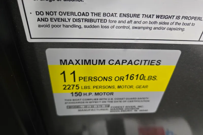Slide: The Image of Maximum capacity label for Dockside 22DQ275 boat, 11 persons or 1610 lbs, 150 HP motor. - 13