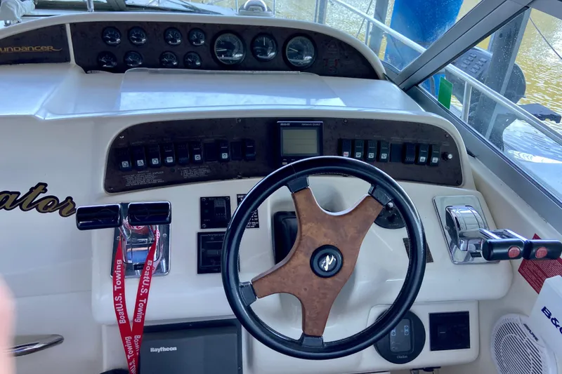 Slide: The Image of 1995 Sea Ray Sundancer 370 helm with steering wheel, controls, and instrument panel. - 10