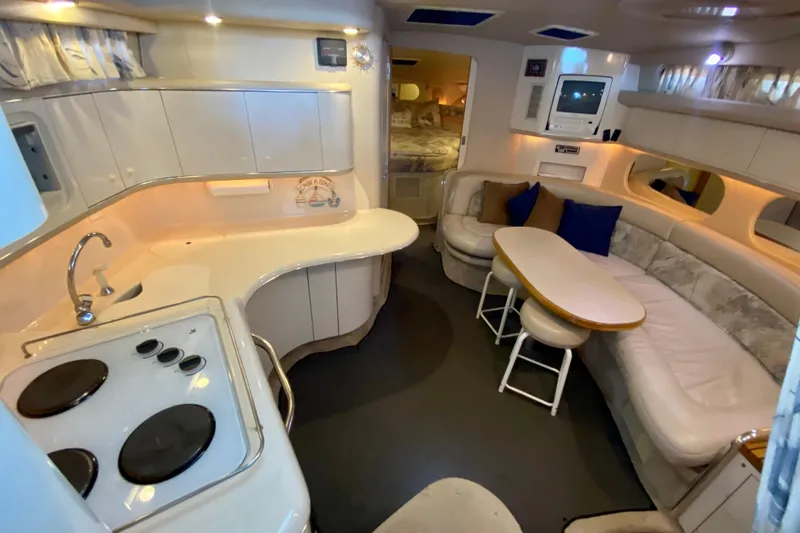 Slide: The Image of Luxurious interior of 1995 Sea Ray Sundancer 370 yacht with kitchen and seating area. - 11