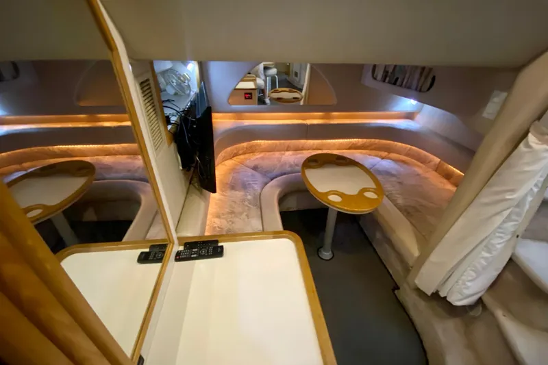 Slide: The Image of Interior of 1995 Sea Ray Sundancer 370 yacht with cozy seating and ambient lighting. - 16