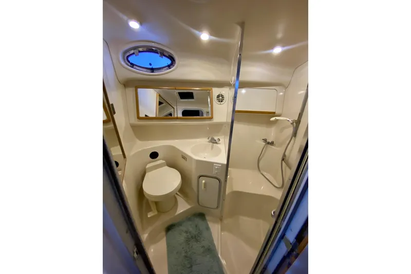 Slide: The Image of 1995 Sea Ray Sundancer 370 bathroom with toilet, sink, shower, and mirror. - 19
