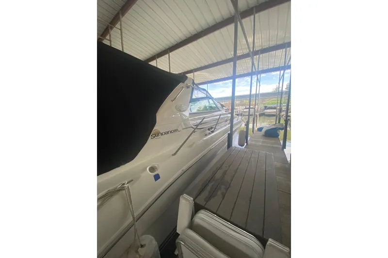 Slide: The Image of 1995 Sea Ray Sundancer 370 docked under a covered marina, side view. - 21