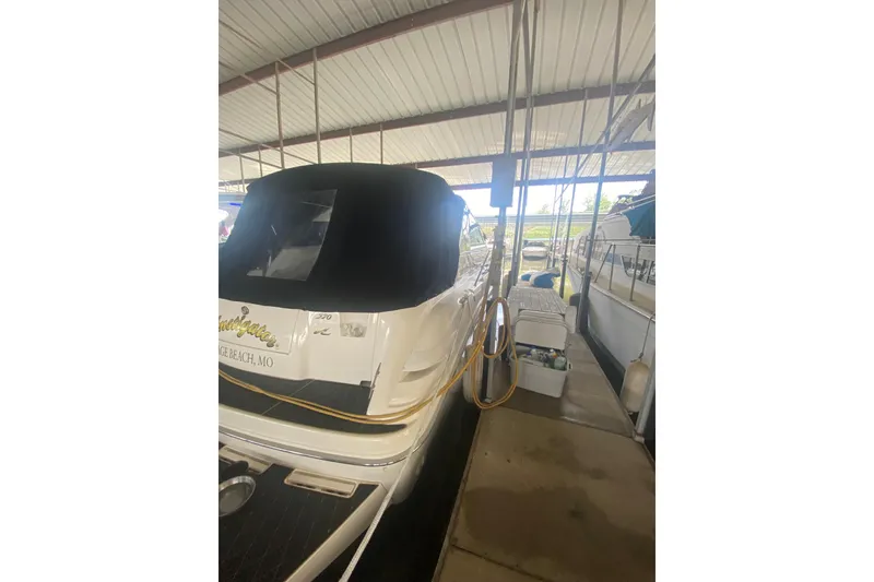 Slide: The Image of 1995 Sea Ray Sundancer 370 docked under a covered marina. - 3