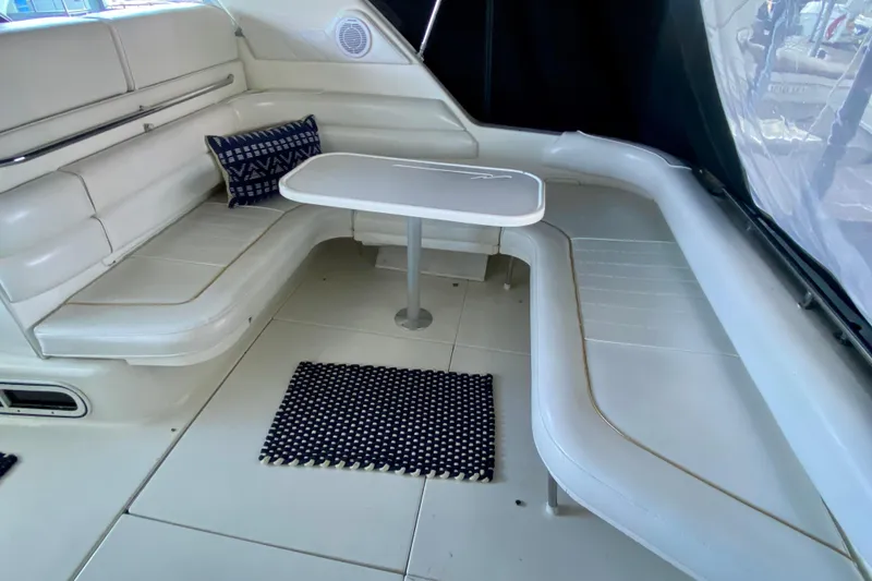 Slide: The Image of Interior seating area of a 1995 Sea Ray Sundancer 370 yacht with table and cushions. - 4