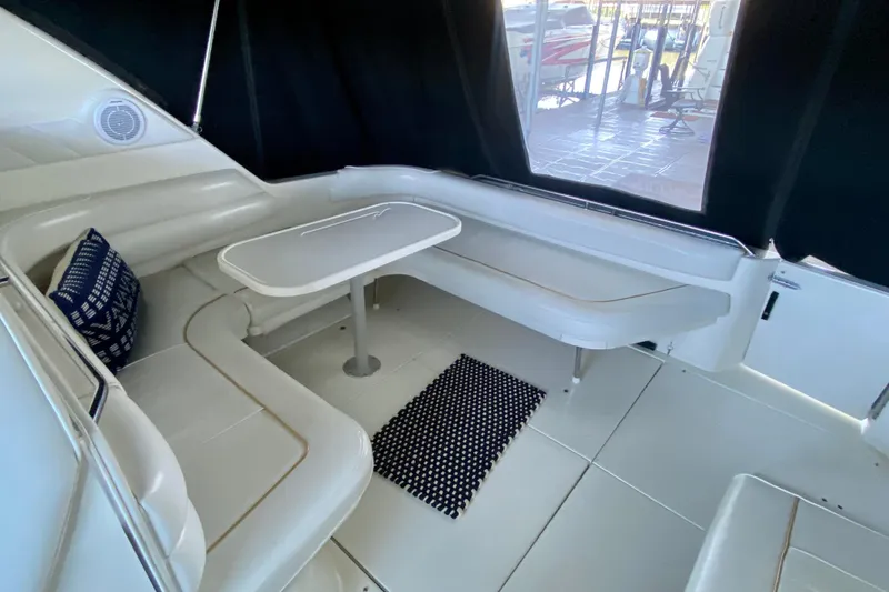 Slide: The Image of Interior of 1995 Sea Ray Sundancer 370 with white seating and table. - 5
