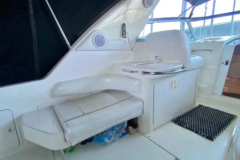 Slide: The Image of Interior of a 1995 Sea Ray Sundancer 370 yacht, featuring seating and a compact sink area. - 6