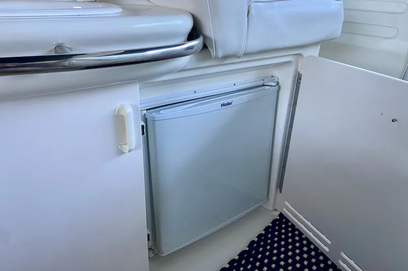 Slide: The Image of Mini fridge inside 1995 Sea Ray Sundancer 370 boat, with open cabinet door. - 7