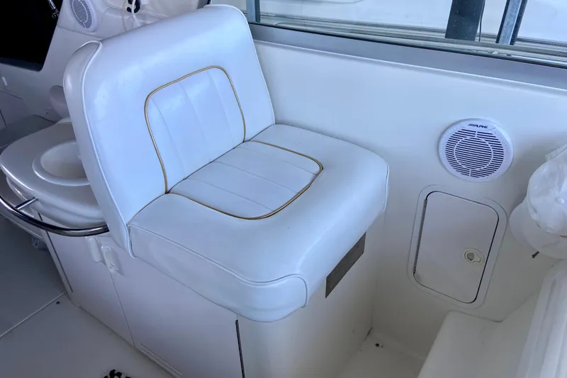Slide: The Image of White seating area on a 1995 Sea Ray Sundancer 370 boat, featuring a speaker and storage compartment. - 8