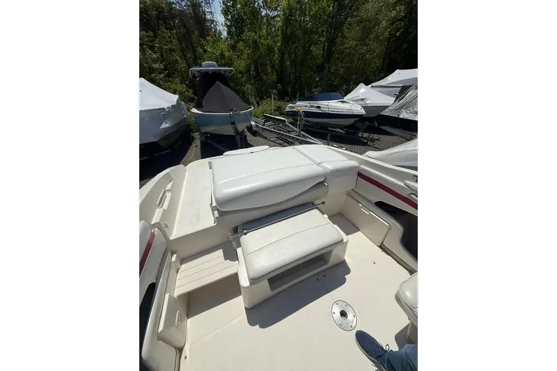 Slide: The Image of 2004 Maxum 2200 SR3 boat interior with white seating, parked outdoors. - 4