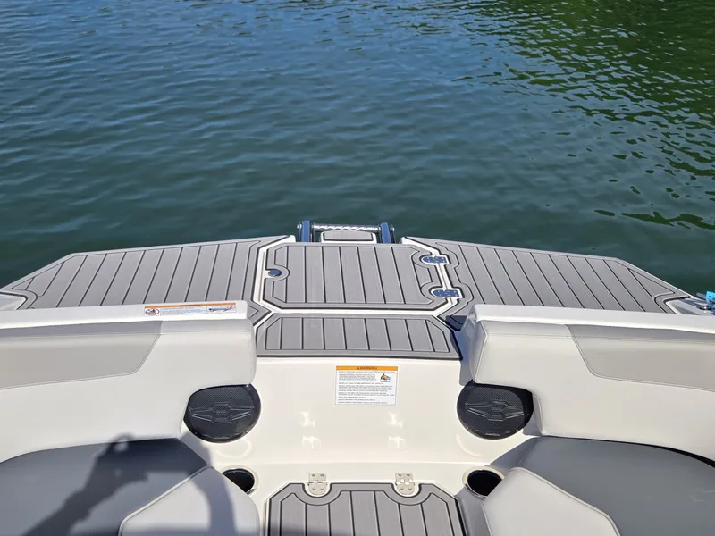 Slide: The Image of The image shows the stern of a Starcraft 211SVXOB boat with a gray deck and water in the background. - 19