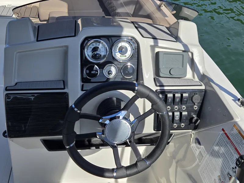 Slide: The Image of The image shows the helm of a Starcraft 211SVXOB boat with modern gauges and a sleek steering wheel. - 13