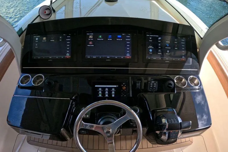 Slide: The Image of Helm of 2018 Scout 380 LXF boat with advanced navigation displays and controls. - 4