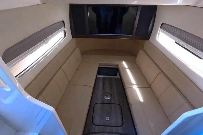 Slide: The Image of Luxurious interior of 2018 Scout 380 LXF boat with beige seating and wood flooring. - 6