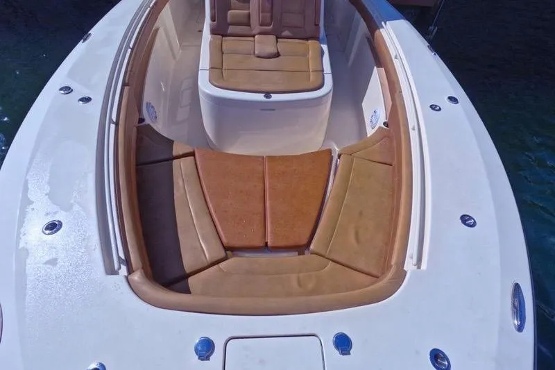 Slide: The Image of 2018 Scout 380 LXF boat with tan seating and sleek design. - 9