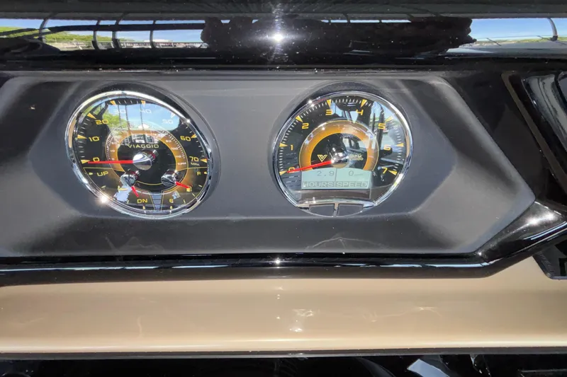 Slide: The Image of Dashboard of a 2026 Viaggio Z24U with dual analog gauges. - 16