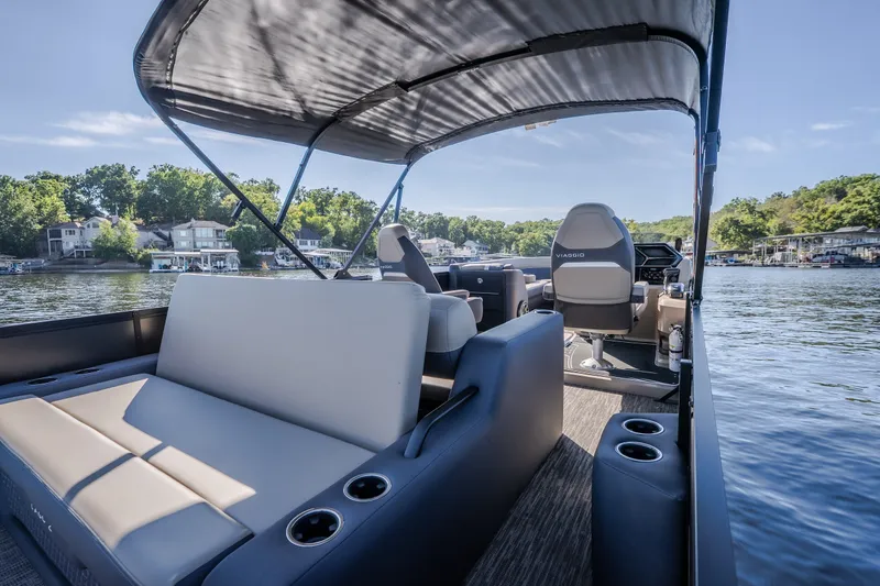 Slide: The Image of Luxurious 2026 Viaggio Z24S pontoon boat interior with plush seating and scenic lake view. - 18