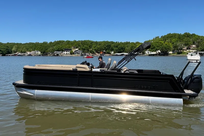Slide: The Image of 2026 Viaggio Z24U pontoon boat on a lake, featuring sleek black design and spacious seating. - 4