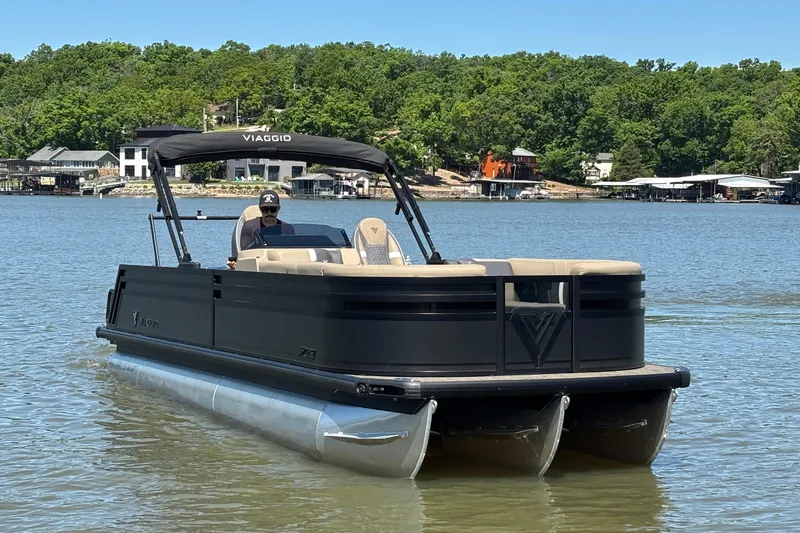 Slide: The Image of 2026 Viaggio Z24U pontoon boat on a scenic lake with lush green shoreline. - 8