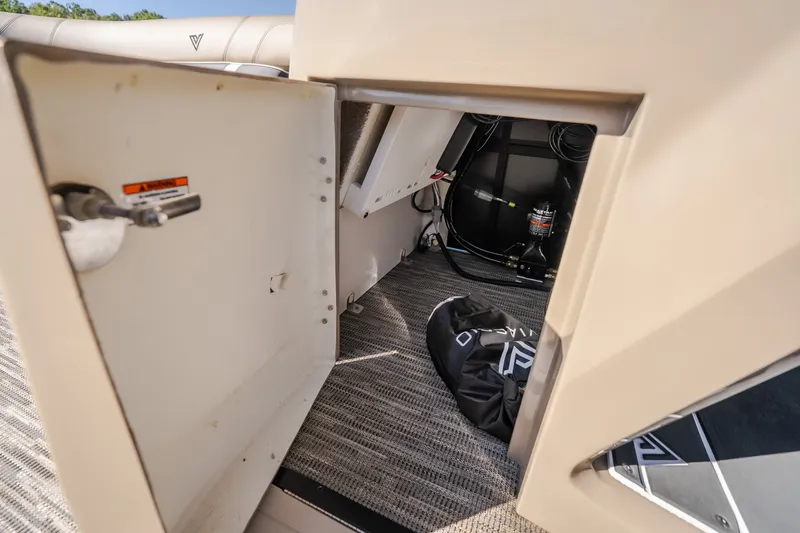 Slide: The Image of Open storage compartment in 2026 Viaggio Z24S boat, showing interior equipment and bag. - 24