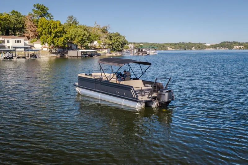 Slide: The Image of 2026 Viaggio Z24S pontoon boat on a serene lake with scenic shoreline. - 47