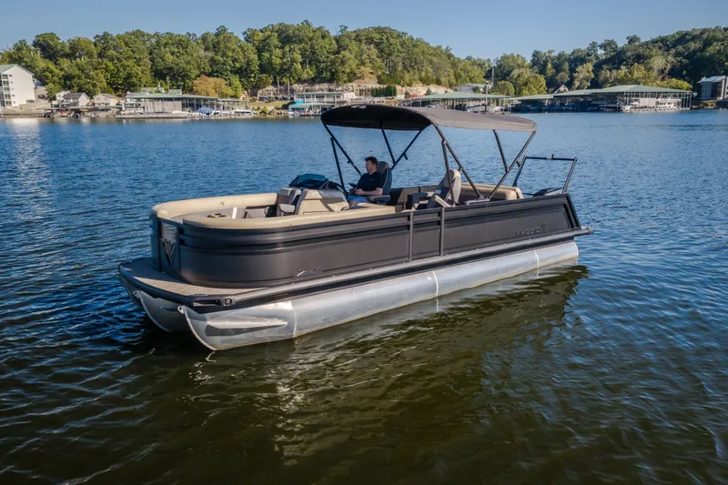The Image of 2026 Viaggio Z24S pontoon boat on a serene lake with lush green shoreline. - 2