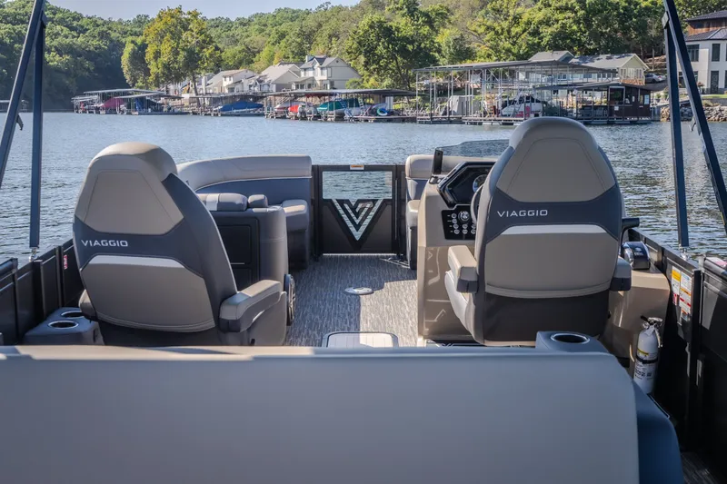 Slide: The Image of Interior view of 2026 Viaggio Z24S boat with luxurious seating and scenic lake backdrop. - 16