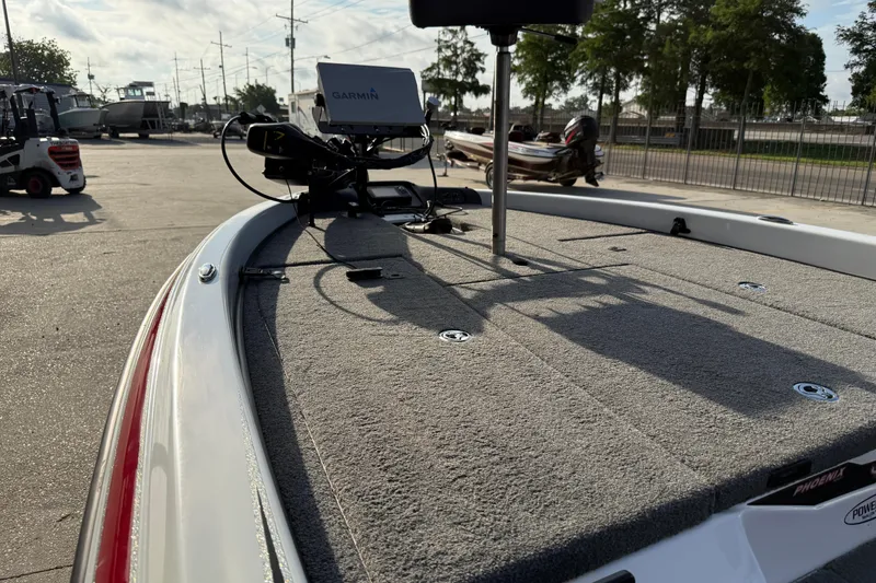 Slide: The Image of 2019 Phoenix 819 Pro boat deck with Garmin equipment, parked outdoors. - 12