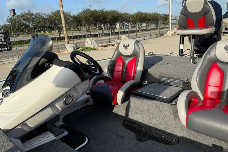 Slide: The Image of 2019 Phoenix 819 Pro boat interior with red and gray seats, steering wheel, and console. - 14