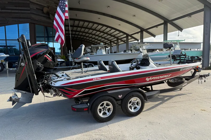 Slide: The Image of 2019 Phoenix 819 Pro boat with trailer, parked under a large canopy. - 6