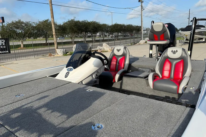 Slide: The Image of 2019 Phoenix 819 Pro boat with red and gray seating, parked outdoors. - 8