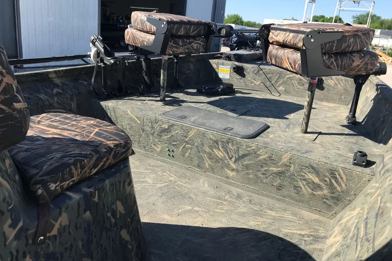 Slide: The Image of 2015 War Eagle 961 Blackhawk boat interior with camouflage seating and fishing equipment. - 14