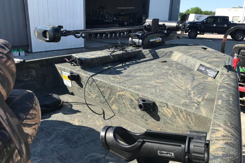 Slide: The Image of 2015 War Eagle 961 Blackhawk boat with Minn Kota trolling motor in a garage setting. - 15