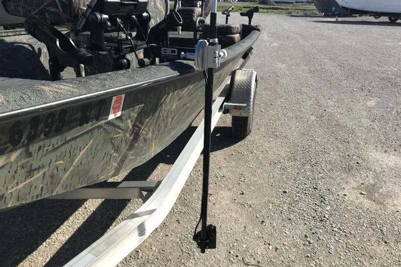 Slide: The Image of 2015 War Eagle 961 Blackhawk boat on trailer, featuring camouflage design and mounted equipment. - 17