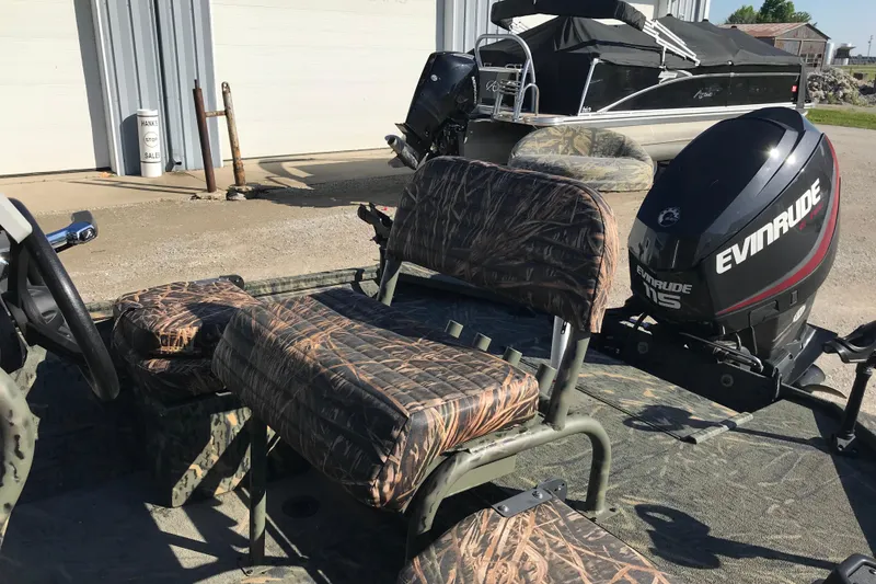 Slide: The Image of 2015 War Eagle 961 Blackhawk boat with camo seats and Evinrude motor. - 8