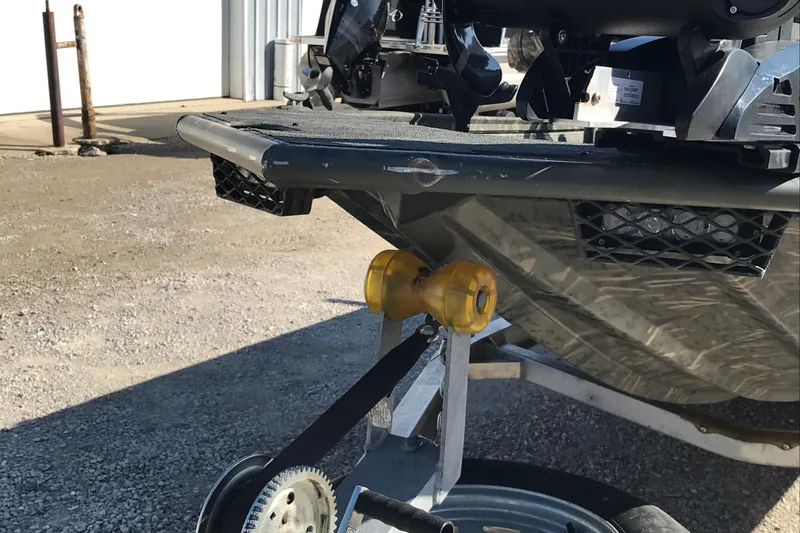 Slide: The Image of 2015 War Eagle 961 Blackhawk boat on trailer, close-up of hull and roller. - 9