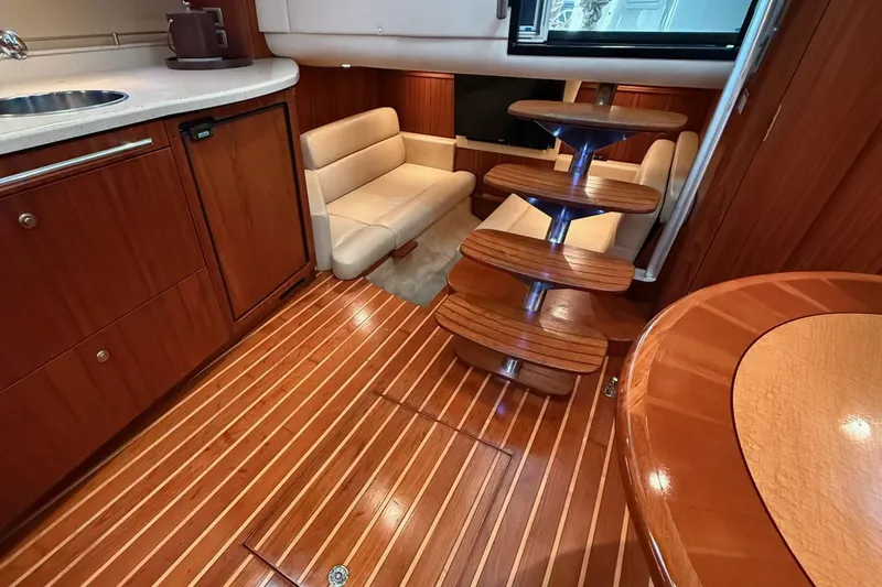 Slide: The Image of Luxurious interior of 2008 Tiara Yachts 3500 Sovran with wooden flooring and seating area. - 11