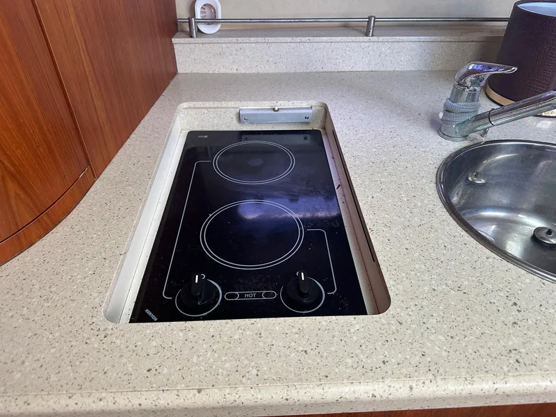 Slide: The Image of 2008 Tiara Yachts 3500 Sovran kitchen with electric stove and sink. - 14