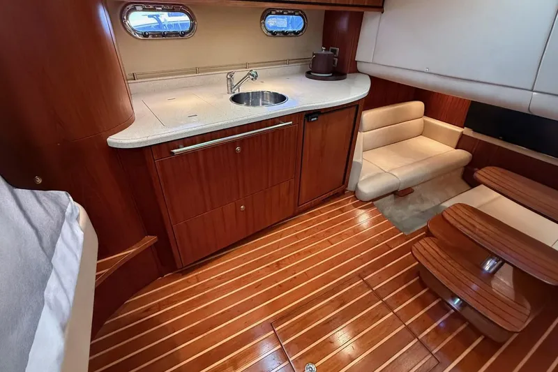 Slide: The Image of Luxurious interior of 2008 Tiara Yachts 3500 Sovran with wood flooring and elegant seating. - 16