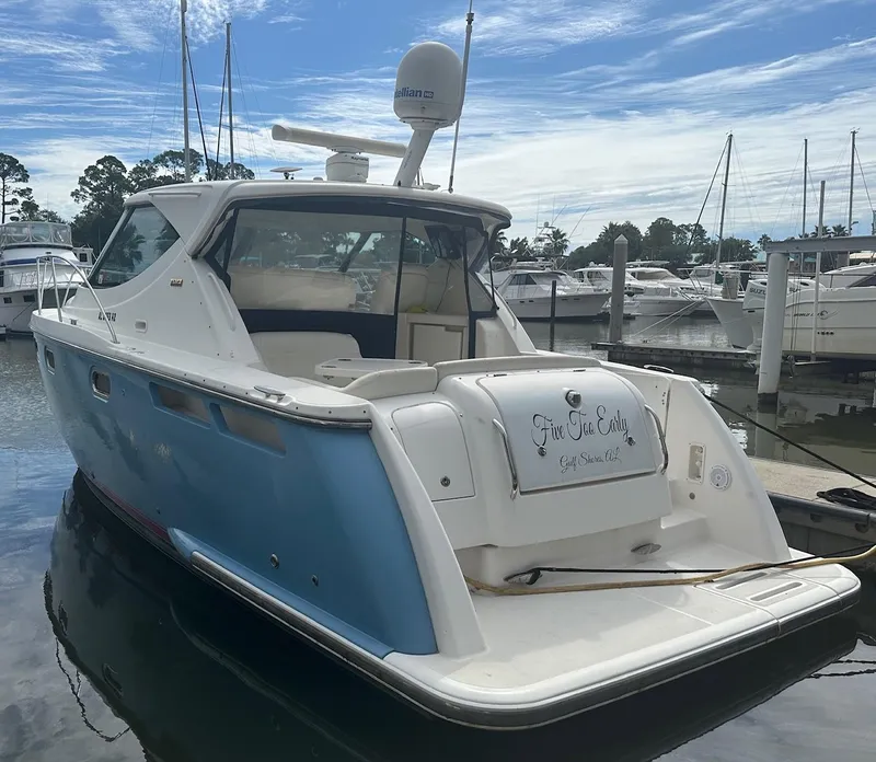 Slide: The Image of 2008 Tiara Yachts 3500 Sovran docked at marina, blue and white exterior. - 3