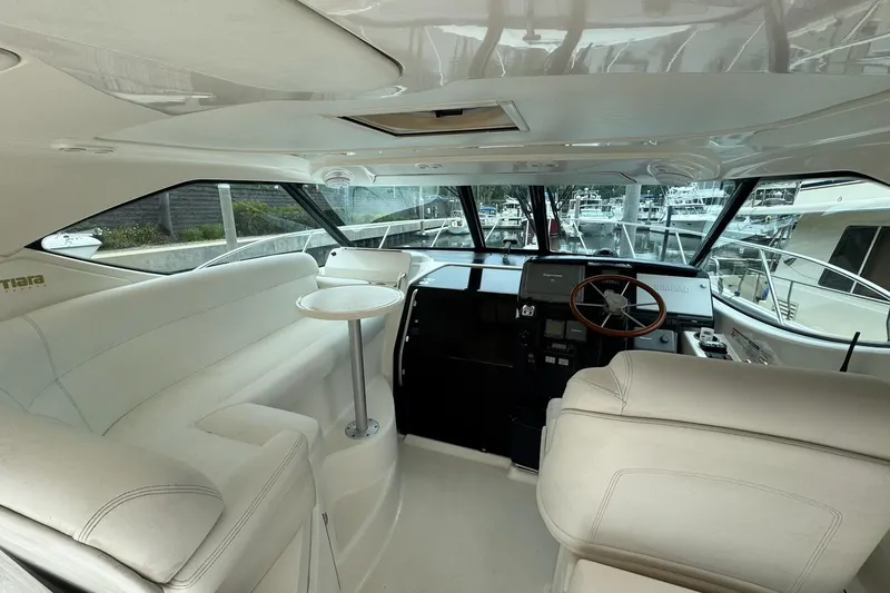Slide: The Image of 2008 Tiara Yachts 3500 Sovran interior with white seating and helm station. - 7