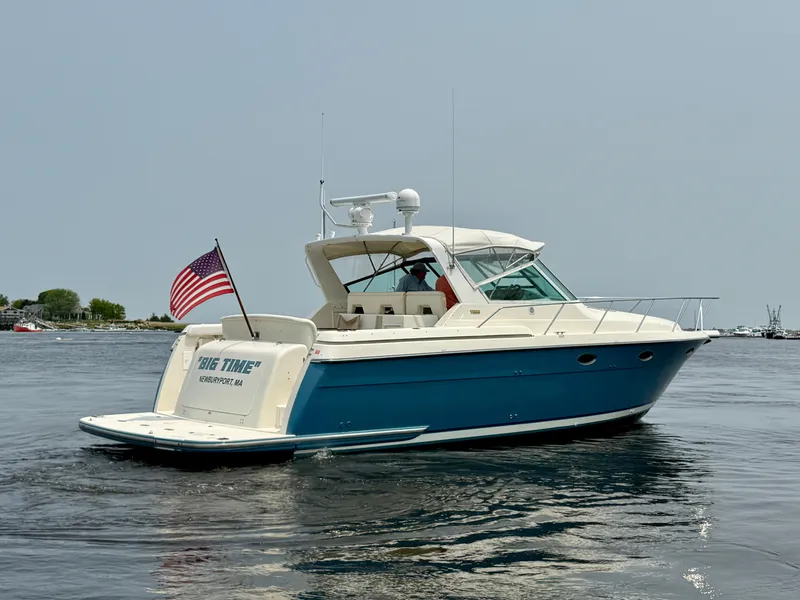 The Image of 1996 Tiara Yachts 3500 Express on calm water with US flag. - 0