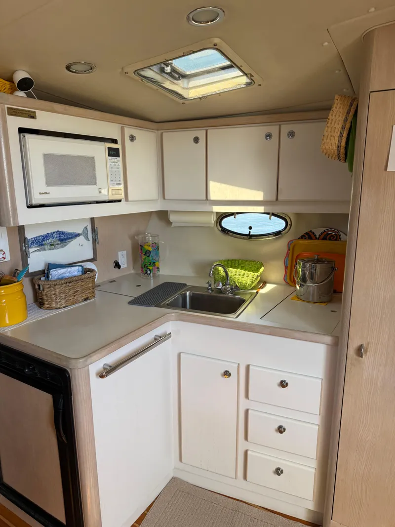 Slide: The Image of 1996 Tiara Yachts 3500 Express kitchen area. - 17