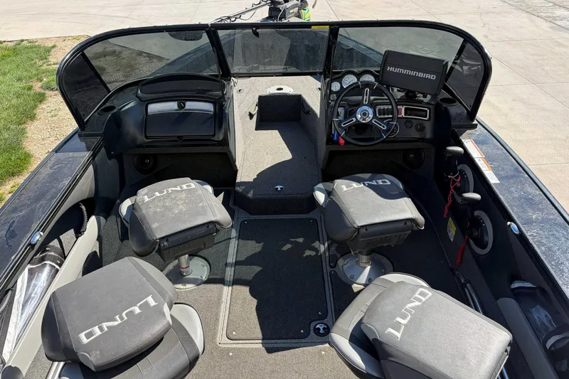 Slide: The Image of 2020 Lund 1875 Crossover XS boat interior with steering wheel and seating. - 4