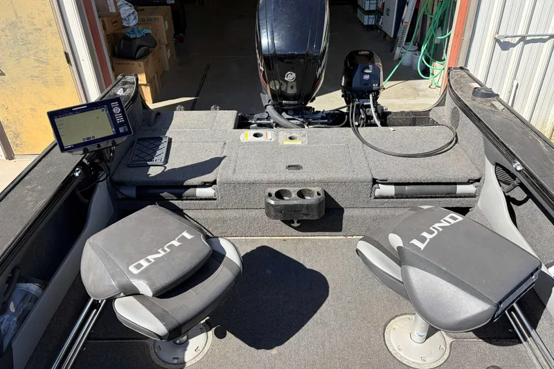 Slide: The Image of 2020 Lund 1875 Crossover XS boat interior with seating and navigation equipment. - 6