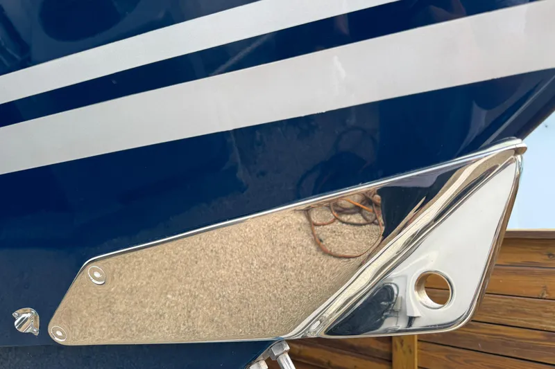 Slide: The Image of Close-up of 2020 HCB 39 Speciale boat's sleek metallic detail and blue-striped hull. - 13