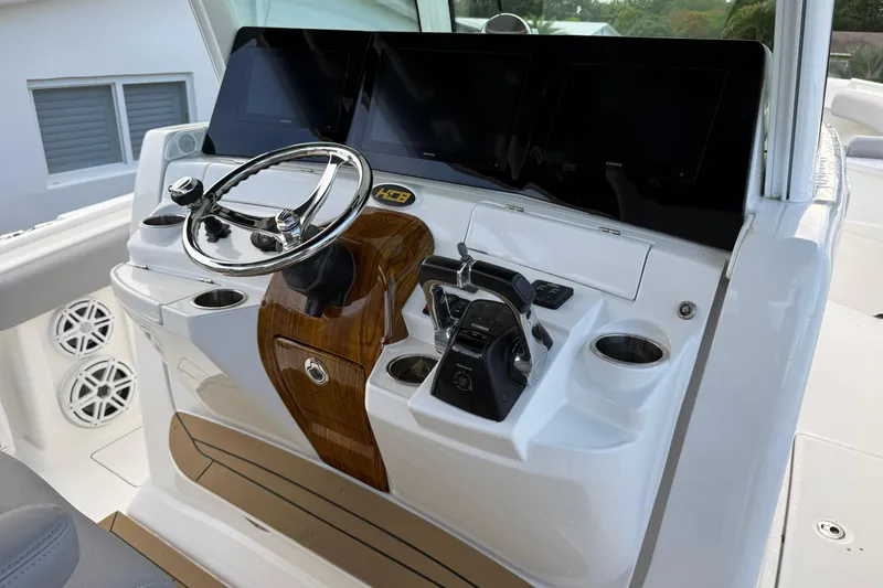 Slide: The Image of Helm of 2020 HCB 39 Speciale boat with modern controls and wood accents. - 15