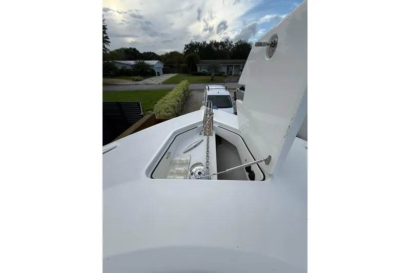 Slide: The Image of 2020 HCB 39 Speciale boat anchor compartment with open hatch, showcasing chain and mechanism. - 17