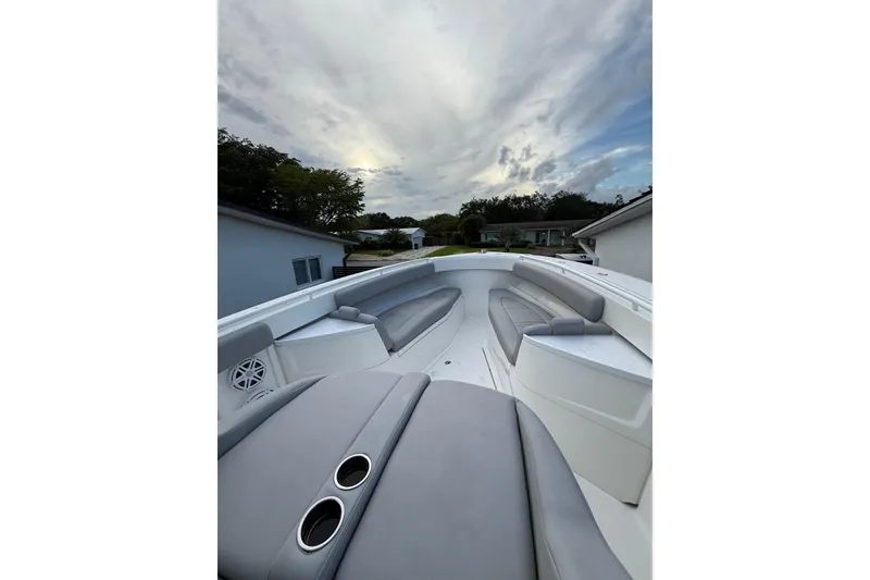Slide: The Image of 2020 HCB 39 Speciale boat interior with gray seating under a cloudy sky. - 24
