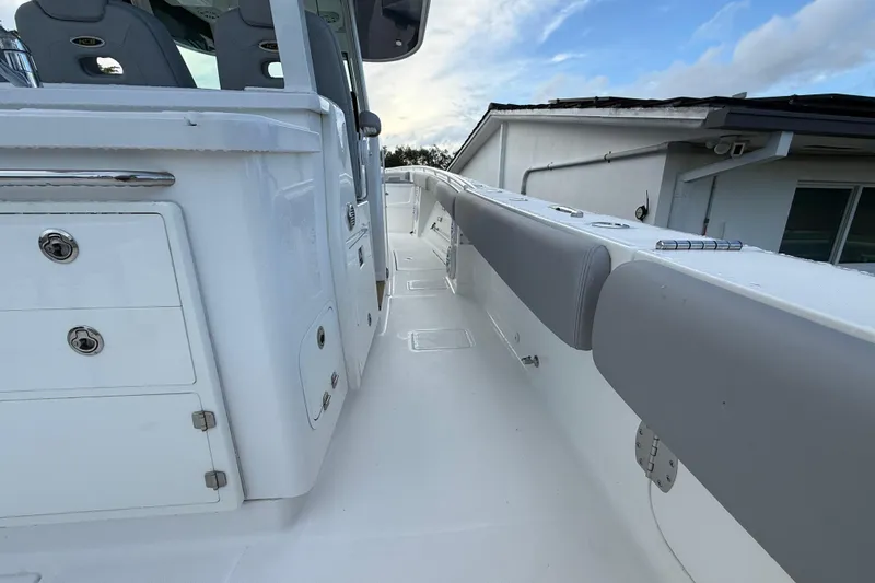 Slide: The Image of 2020 HCB 39 Speciale boat interior with white and gray seating, storage compartments. - 6