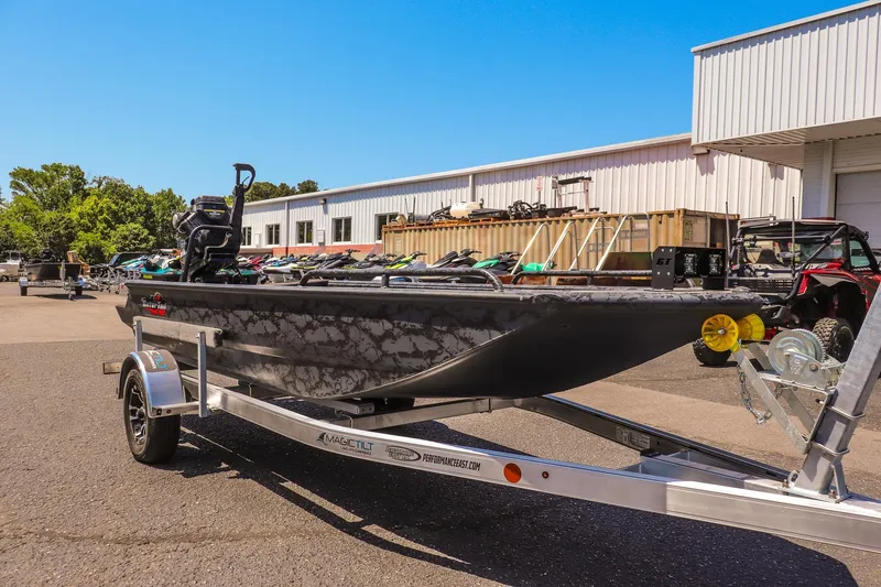 The Image of 2026 Gator Tail 17/50 MID DECK SAVAGE SERIES boat on trailer, outdoor dealership setting. - 1